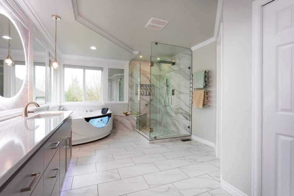 Spacious modern bathroom with large glass-enclosed shower, freestanding bathtub, dual sinks with mirrors, and sleek cabinetry.