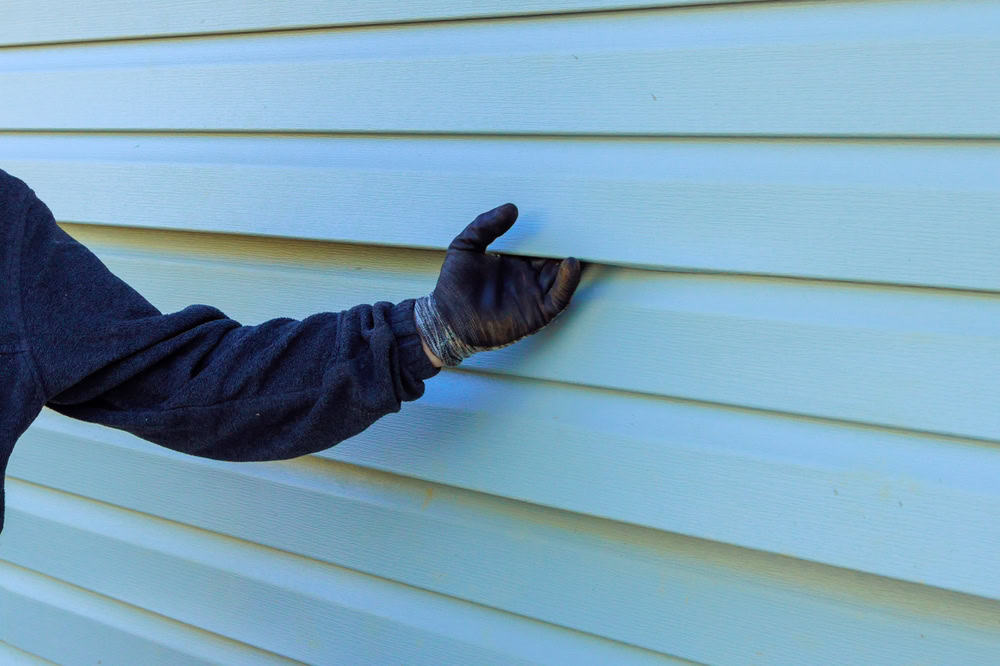 A person in a dark sweatshirt, possibly from a home remodeling team in Orange County, NY.